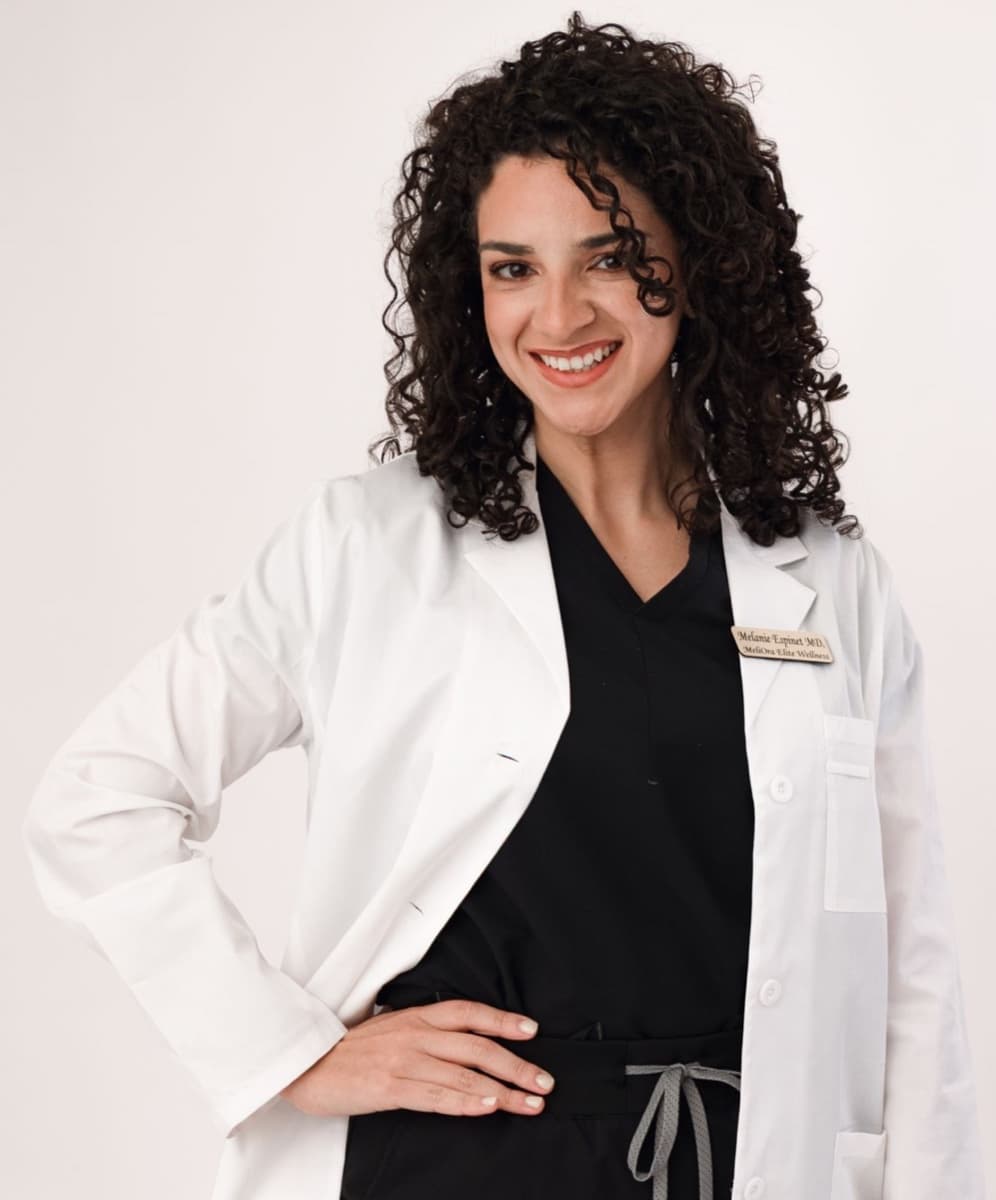 Dr. Melanie Espinet, MD, in her white coat